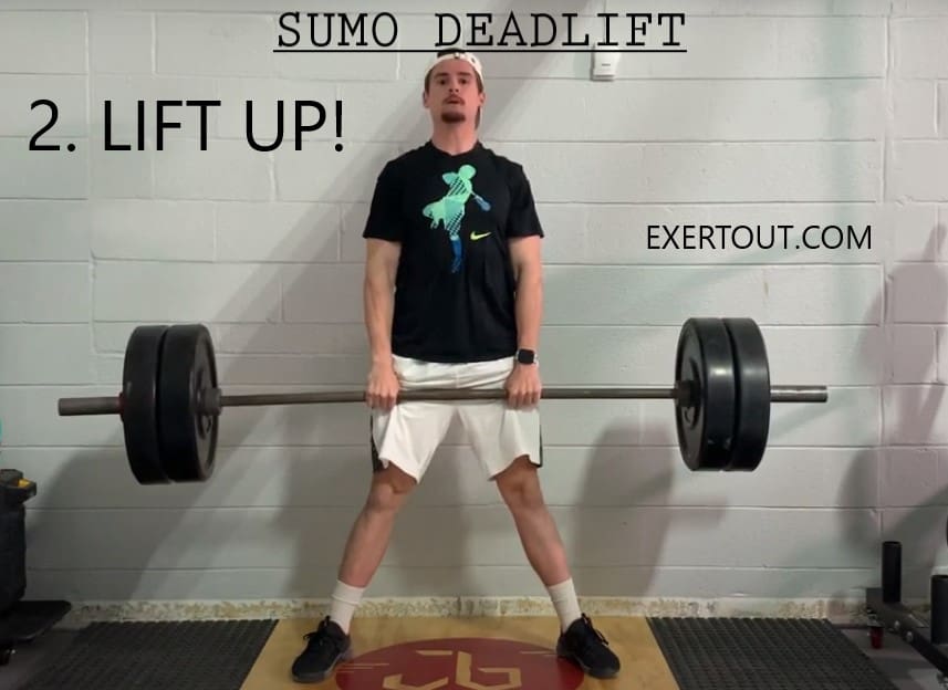LIFTING UP OF THE BARBELL WITH WEIGHTS IN SUMO DEADLIFT